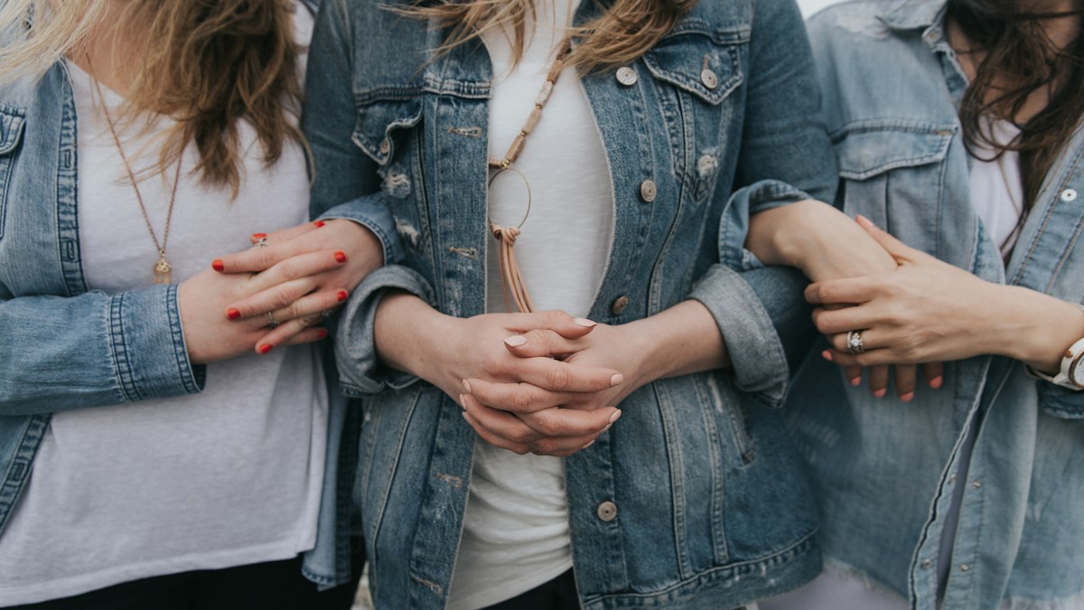 Woman wearing a blue denim jacket with subtle silver jewelry for an evening gala